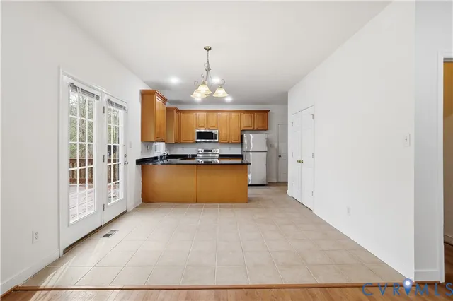 a view of kitchen with refrigerator and window