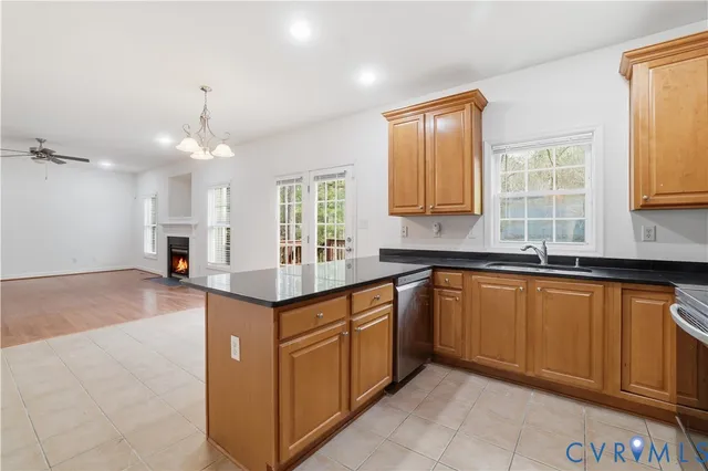 a kitchen with granite countertop a sink cabinets and window