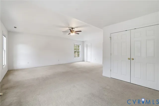 a view of a livingroom with a chandelier fan