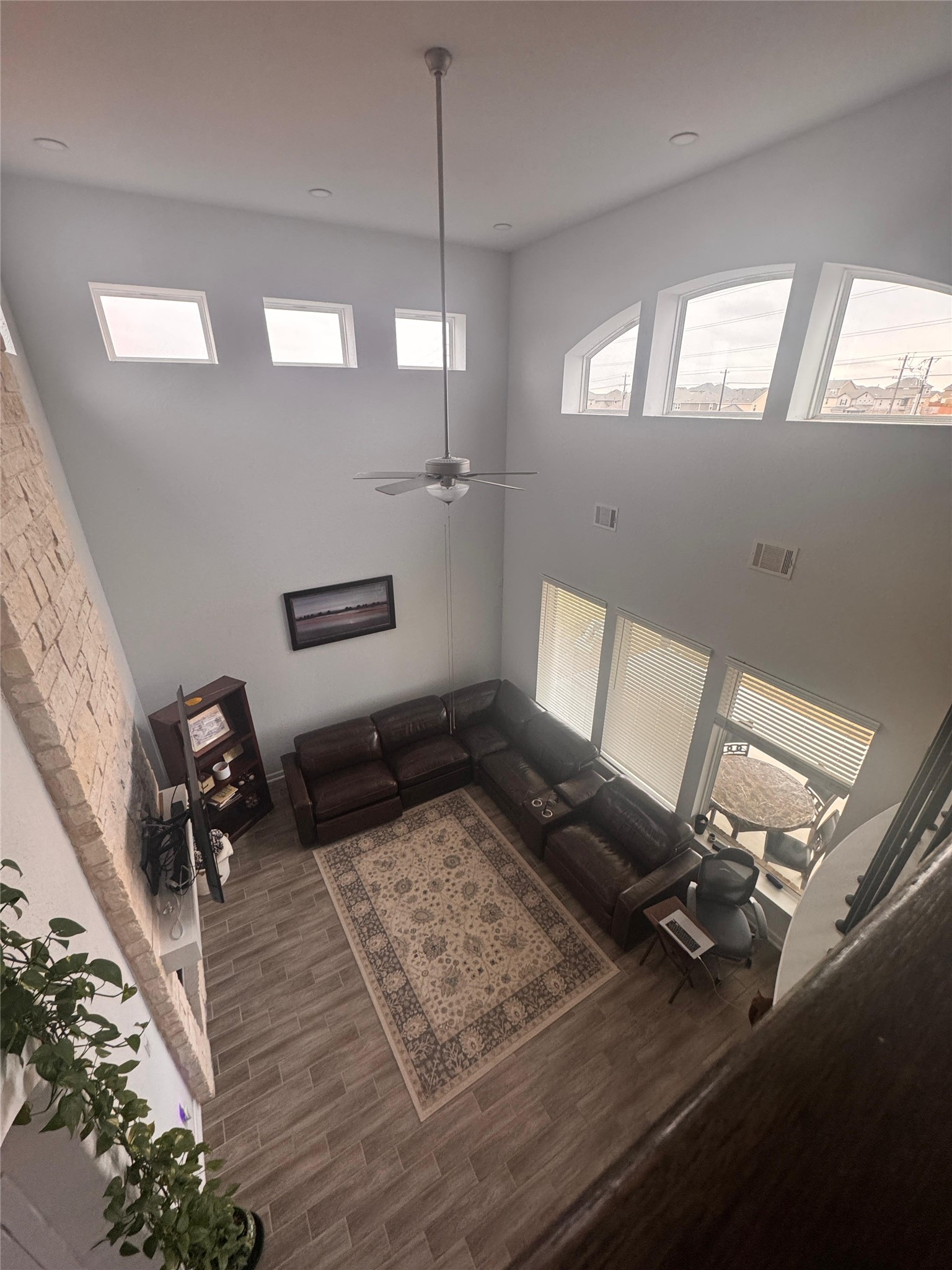 650 Wild Pecan Loop Buda, TX 78610 - Photo 10 of 28 Living room featuring a high ceiling, a ceiling fan, and wood finished floors