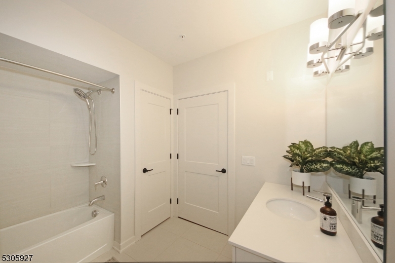 30 Court Street Morristown, NJ 07960 - Photo 12 of 27 a bathroom with a sink a bathtub and a shower