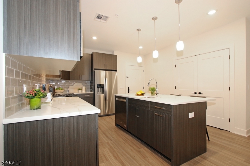 30 Court Street Morristown, NJ 07960 - Photo 5 of 27 a kitchen with a sink a counter top space appliances and cabinets