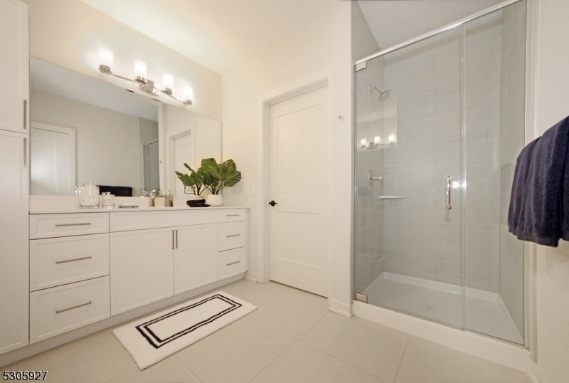 30 Court Street Morristown, NJ 07960 - Photo 8 of 27 a spacious bathroom with a shower sink and mirror