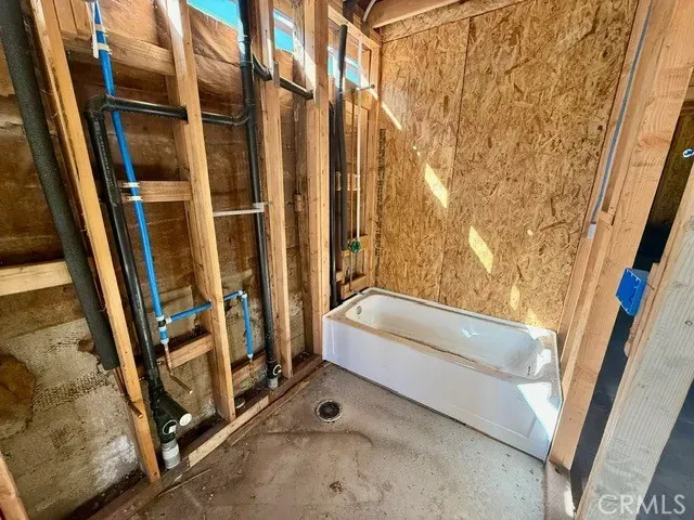 a view of an entryway with wooden floor and fence