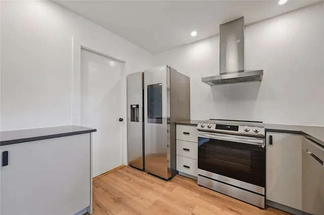 a kitchen with a stove and a refrigerator