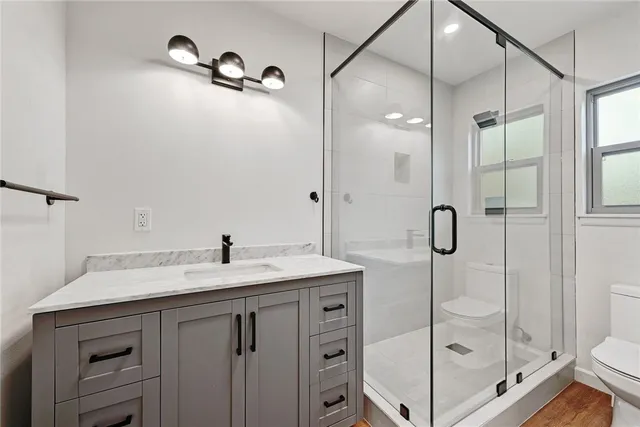 a bathroom with a shower sink and mirror