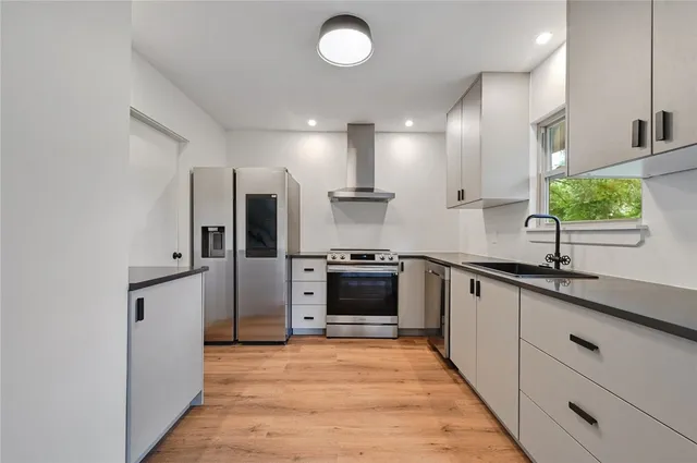 a large kitchen with cabinets and stainless steel appliances