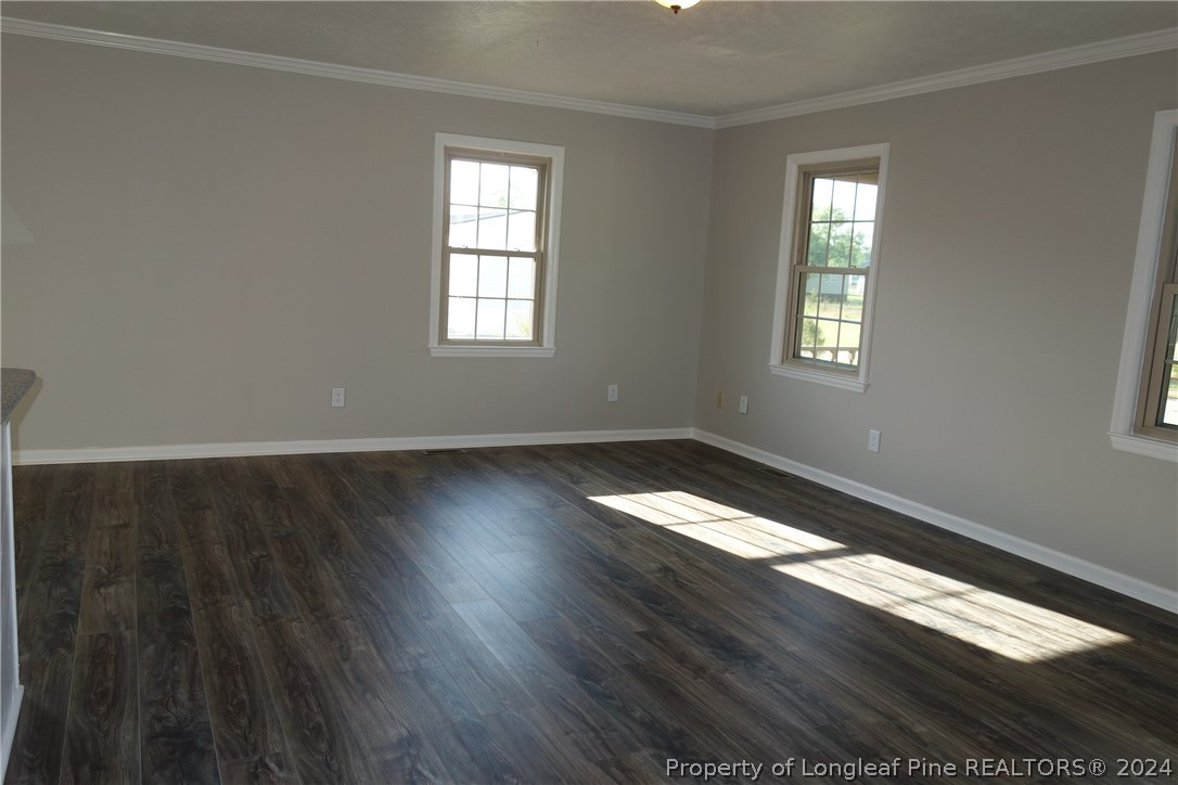 3458 Popes Crossing Road Lumberton, NC 28358 - Photo 17 of 50 wooden floor in an empty room with a window