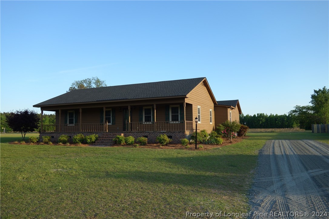 3458 Popes Crossing Road Lumberton, NC 28358 - Photo 2 of 50 a front view of a house with garden