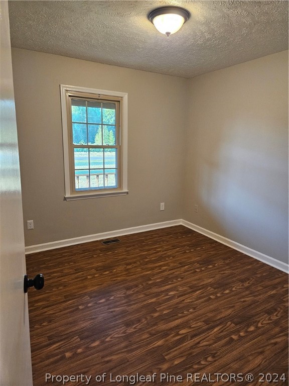 3458 Popes Crossing Road Lumberton, NC 28358 - Photo 38 of 50 an empty room with wooden floor and windows