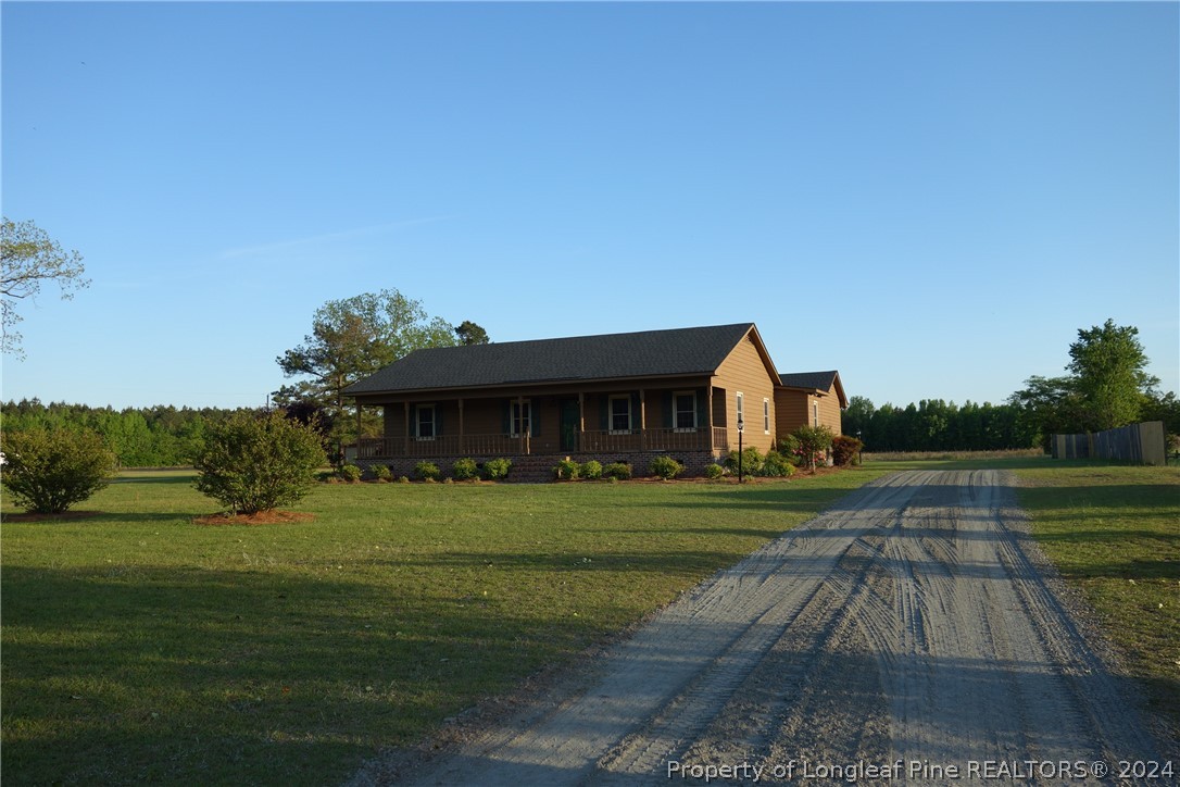 3458 Popes Crossing Road Lumberton, NC 28358 - Photo 43 of 50 a front view of a house with a yard