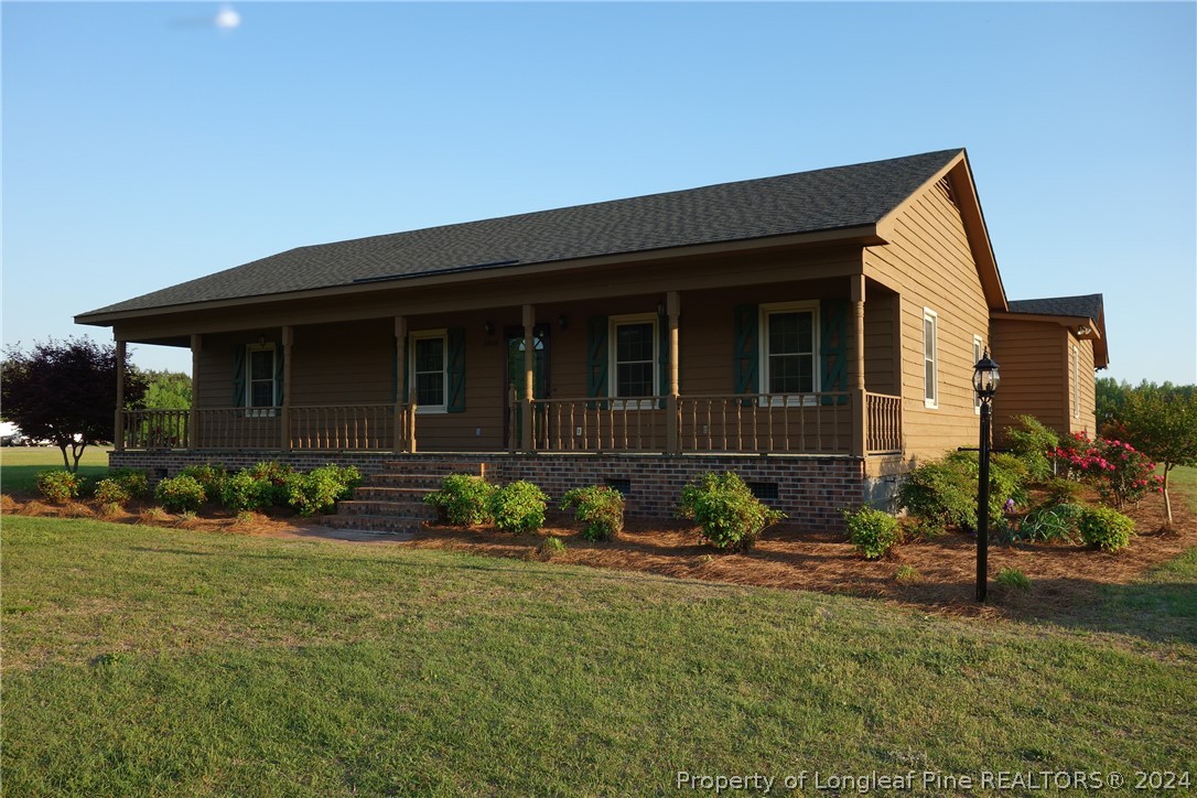 3458 Popes Crossing Road Lumberton, NC 28358 - Photo 50 of 50 a front view of a house with garden