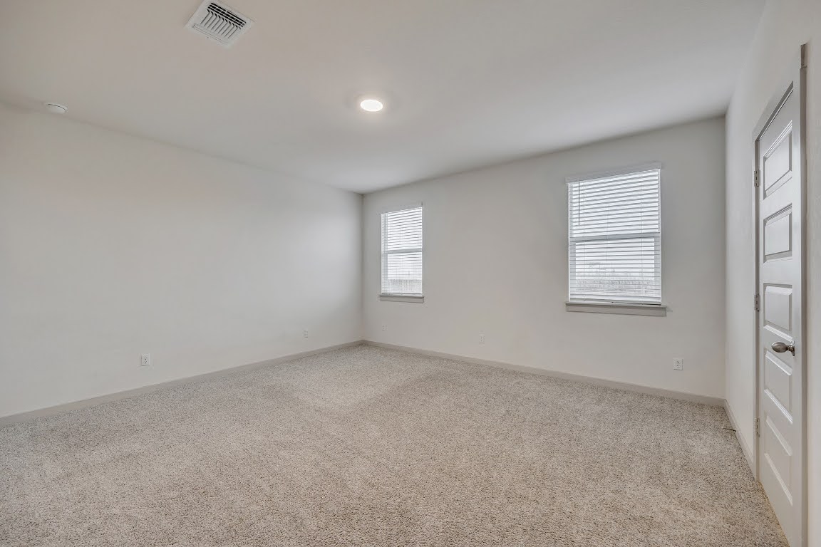 210 Big Cypress Bayou Road Hutto, TX 78634 - Photo 11 of 27 Unfurnished room with light colored carpet and baseboards