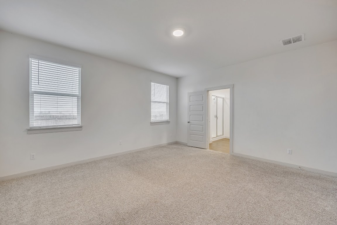 210 Big Cypress Bayou Road Hutto, TX 78634 - Photo 12 of 27 Unfurnished room with light colored carpet and baseboards