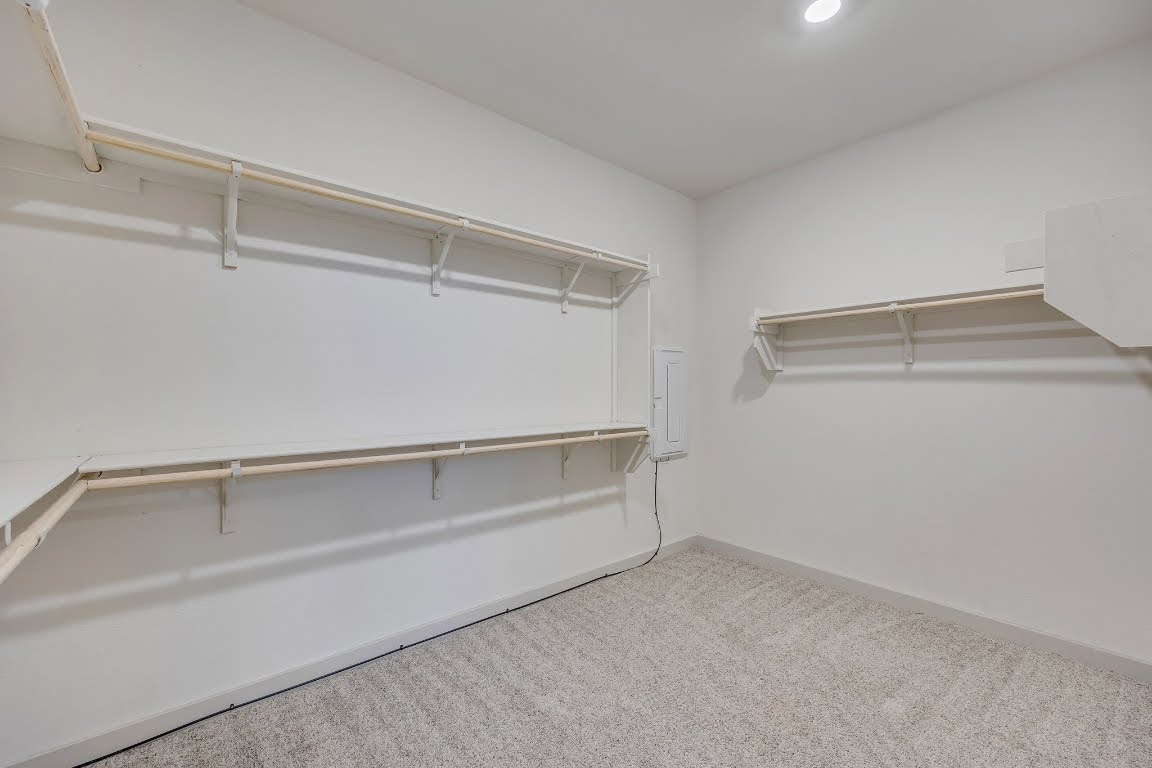 210 Big Cypress Bayou Road Hutto, TX 78634 - Photo 14 of 27 Spacious closet featuring light colored carpet and electric panel