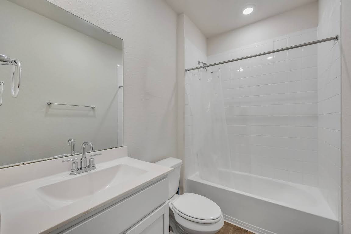 210 Big Cypress Bayou Road Hutto, TX 78634 - Photo 16 of 27 Full bath featuring shower / bathtub combination with curtain, vanity, and recessed lighting