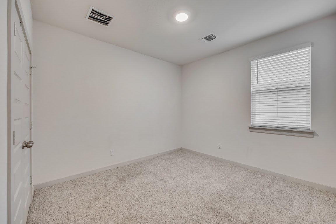 210 Big Cypress Bayou Road Hutto, TX 78634 - Photo 17 of 27 Spare room featuring carpet and baseboards