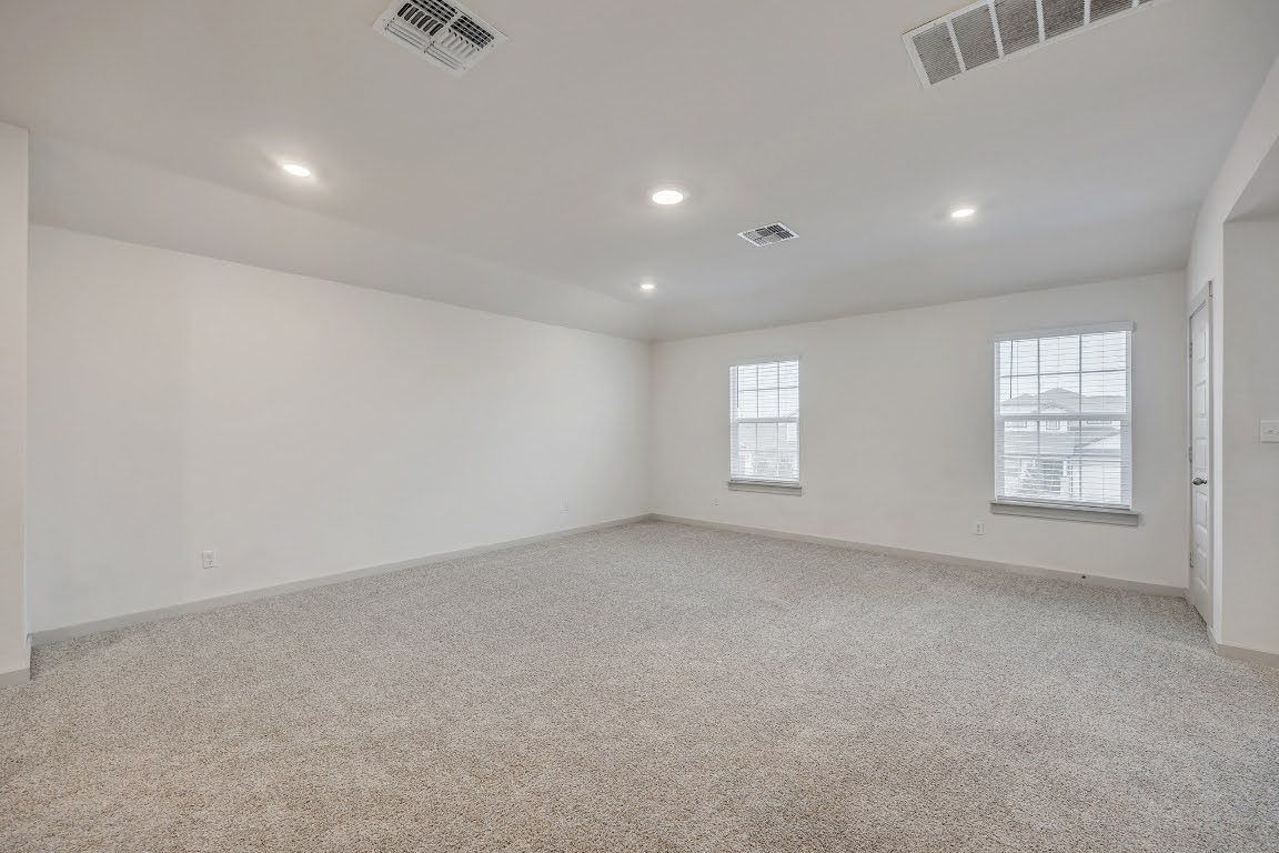 210 Big Cypress Bayou Road Hutto, TX 78634 - Photo 19 of 27 Unfurnished room with light carpet and recessed lighting