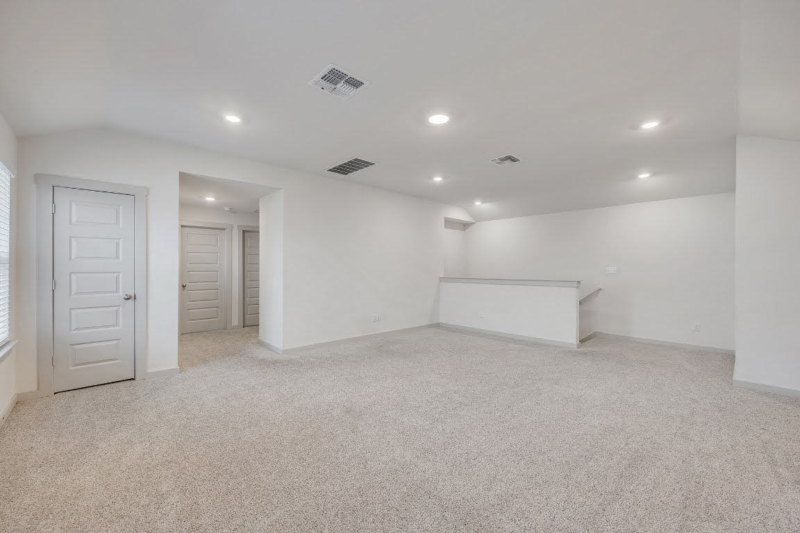 210 Big Cypress Bayou Road Hutto, TX 78634 - Photo 20 of 27 Below grade area with light colored carpet and recessed lighting