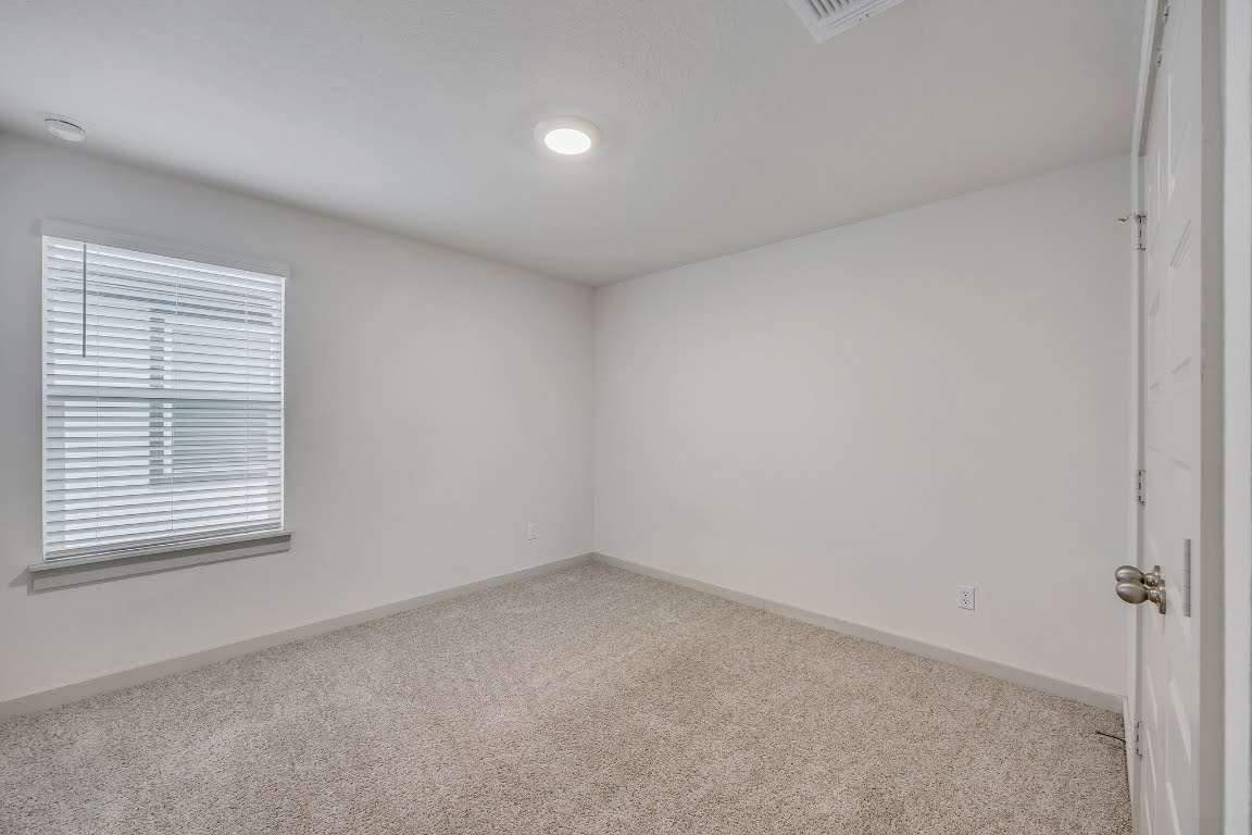 210 Big Cypress Bayou Road Hutto, TX 78634 - Photo 23 of 27 Empty room featuring carpet flooring and baseboards