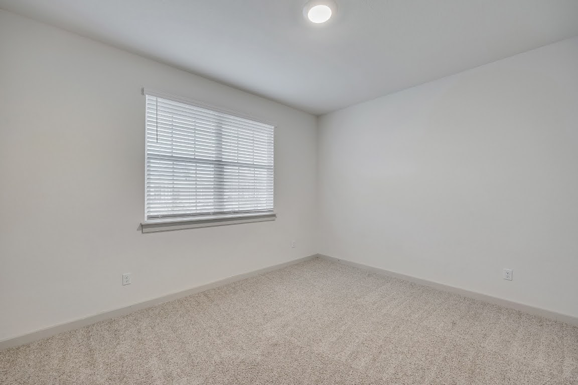 210 Big Cypress Bayou Road Hutto, TX 78634 - Photo 4 of 27 Unfurnished room with carpet floors and baseboards