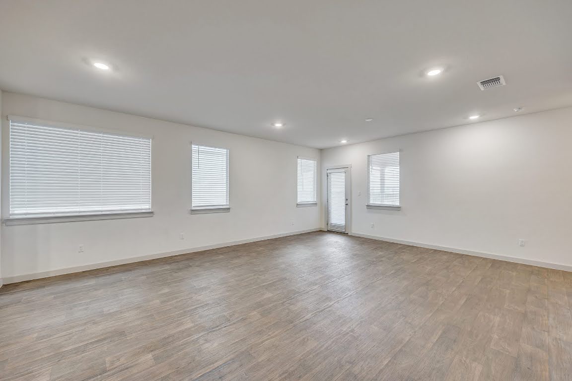 210 Big Cypress Bayou Road Hutto, TX 78634 - Photo 8 of 27 Spare room featuring light wood-style floors and recessed lighting
