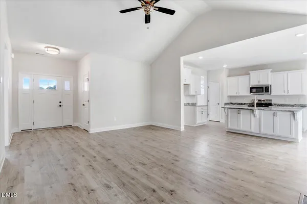 a view of a room with wooden floor and a fireplace