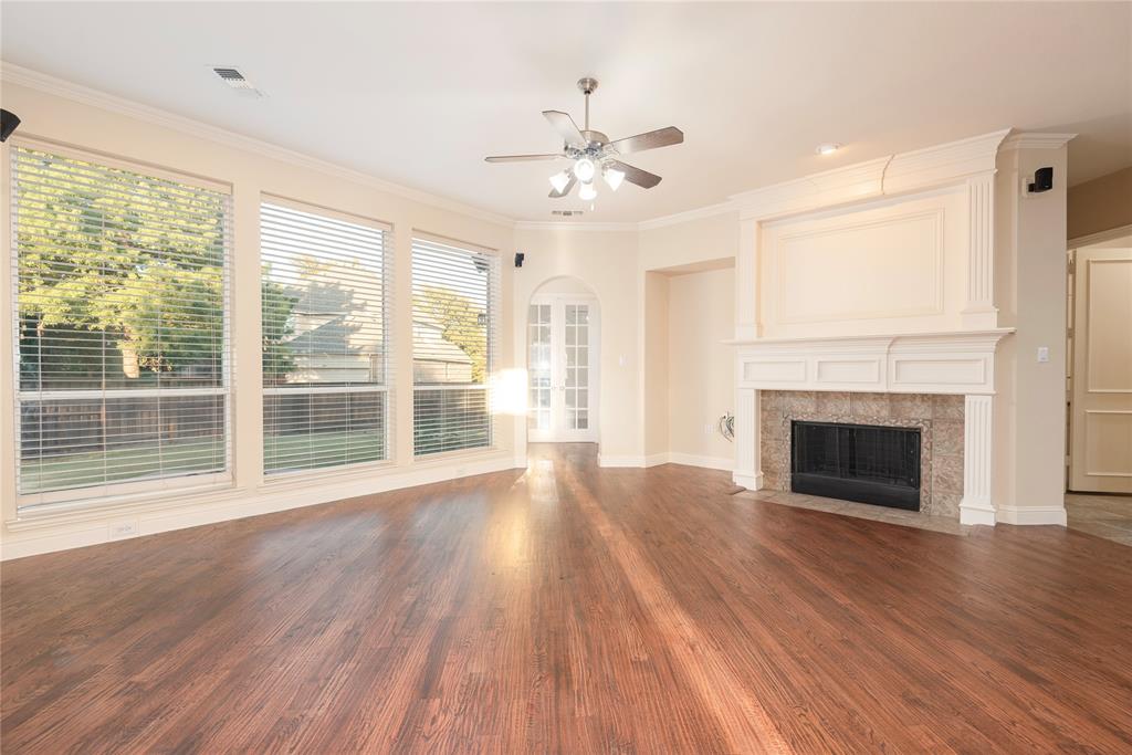 1404 Rio Grande Drive Allen, TX 75013 - Photo 11 of 40 a view of an empty room with wooden floor fireplace and a window