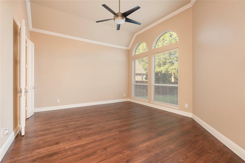 1404 Rio Grande Drive Allen, TX 75013 - Photo 21 of 40 an empty room with wooden floor fan and windows
