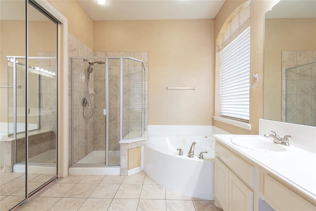 1404 Rio Grande Drive Allen, TX 75013 - Photo 23 of 40 a spacious bathroom with a granite countertop sink a toilet and shower
