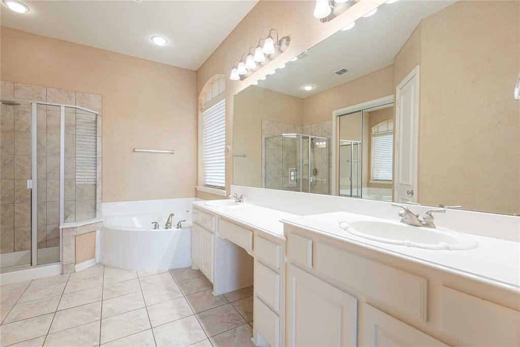 1404 Rio Grande Drive Allen, TX 75013 - Photo 24 of 40 a spacious bathroom with a bathtub shower sink vanity and mirror
