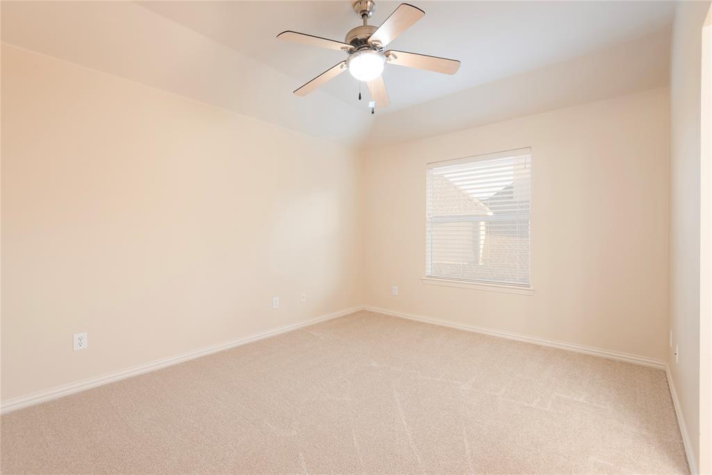 1404 Rio Grande Drive Allen, TX 75013 - Photo 31 of 40 an empty room with a window and a ceiling fan