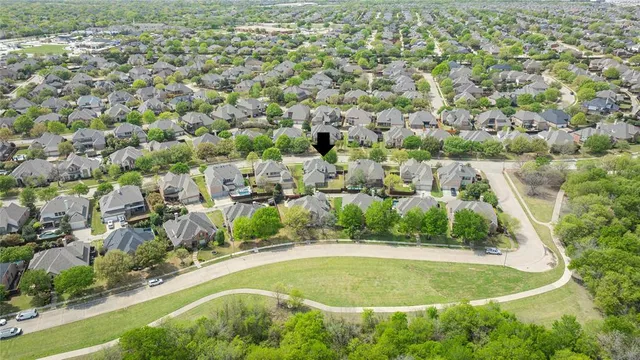 an aerial view of a house with a swimming pool