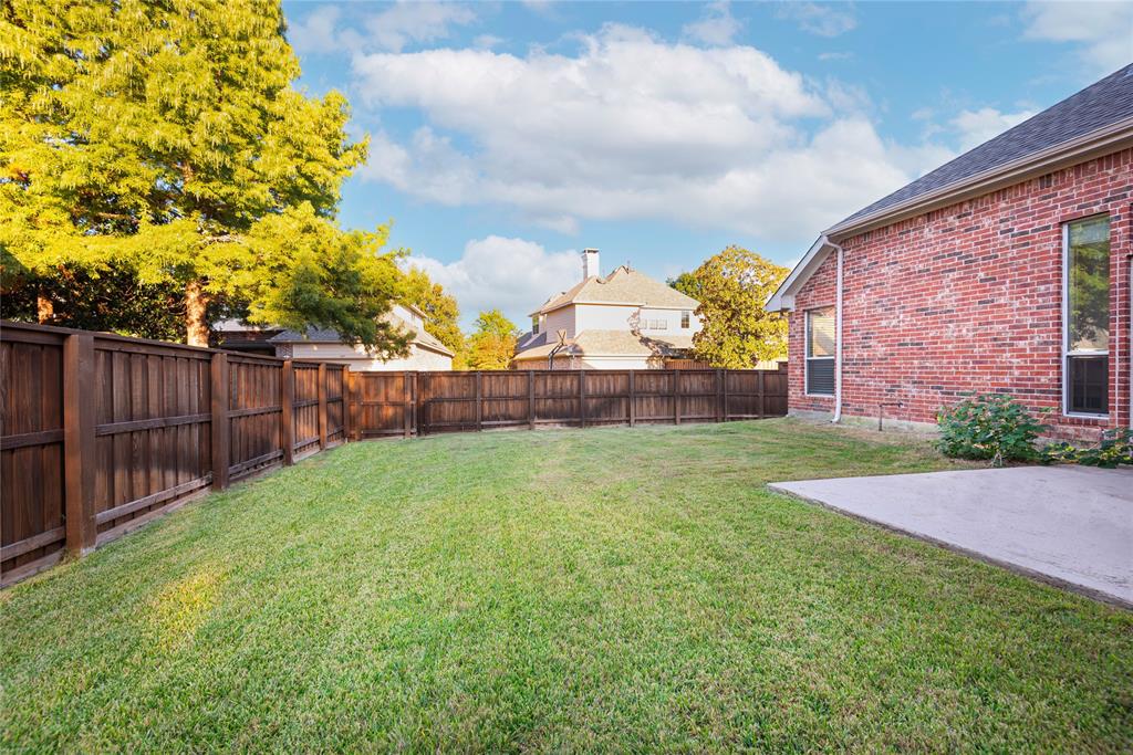 1404 Rio Grande Drive Allen, TX 75013 - Photo 4 of 40 a view of a backyard with wooden fence