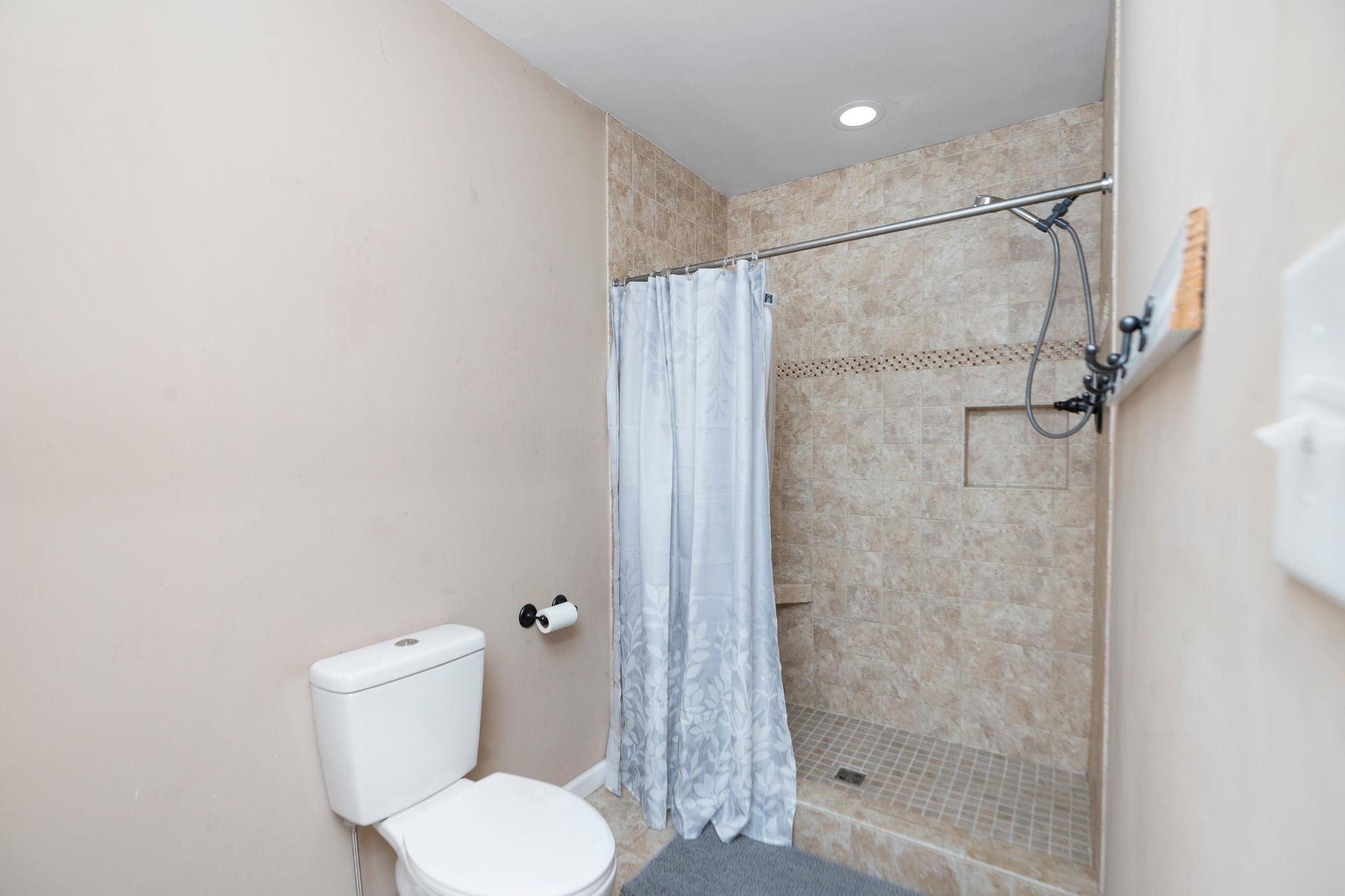 467 Reeds Gap Road Lyndhurst, VA 22952 - Photo 21 of 42 a white toilet sitting next to a shower