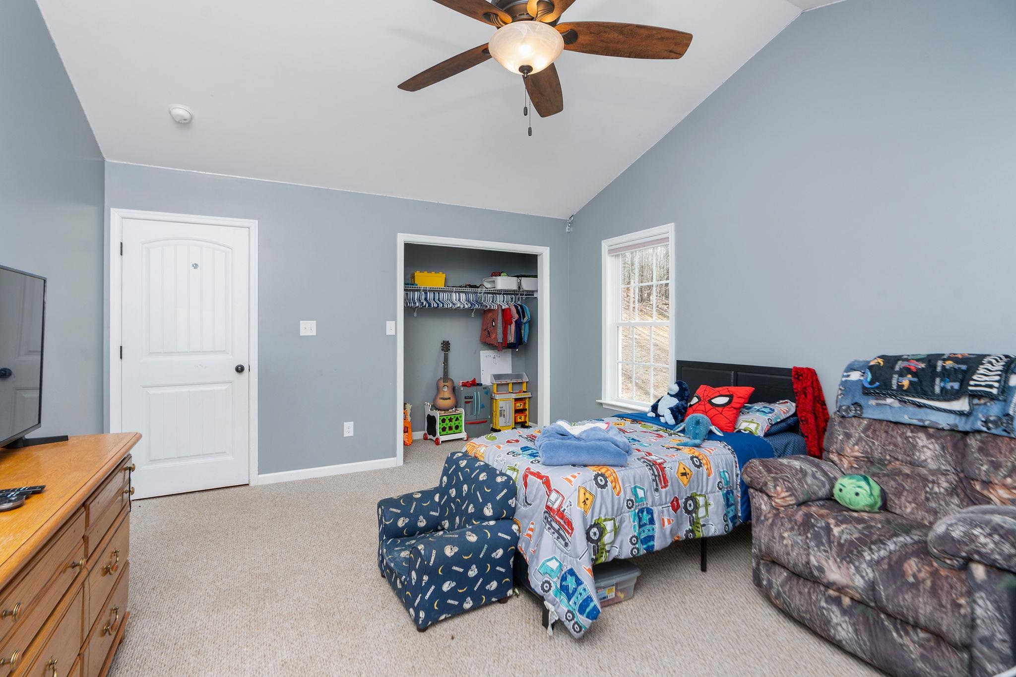 467 Reeds Gap Road Lyndhurst, VA 22952 - Photo 23 of 42 a bedroom with a bed and a chandelier