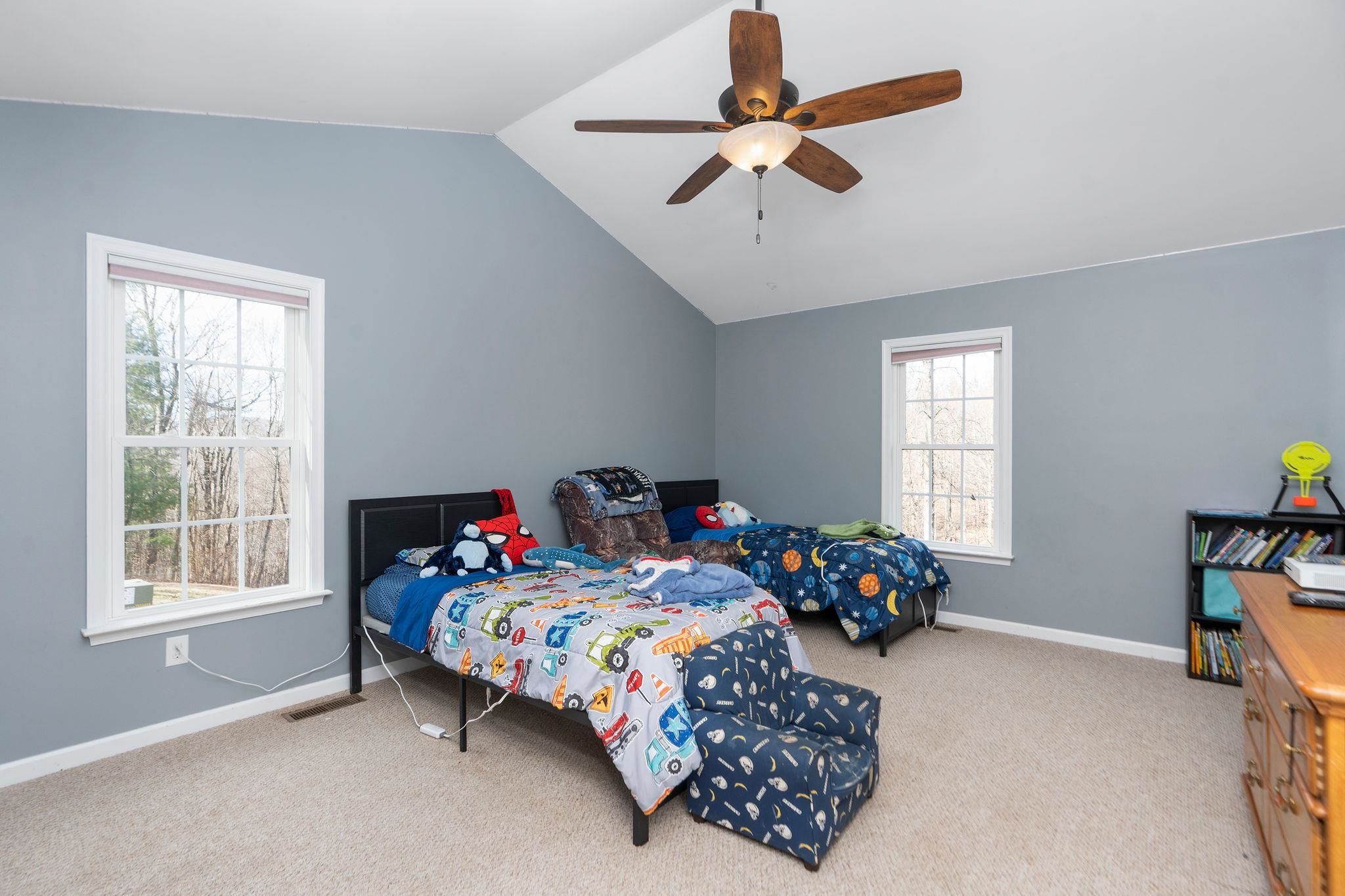467 Reeds Gap Road Lyndhurst, VA 22952 - Photo 24 of 42 a bedroom with a bed and a chandelier