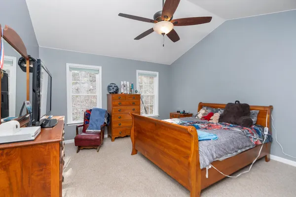 a bedroom with a bed and a chandelier
