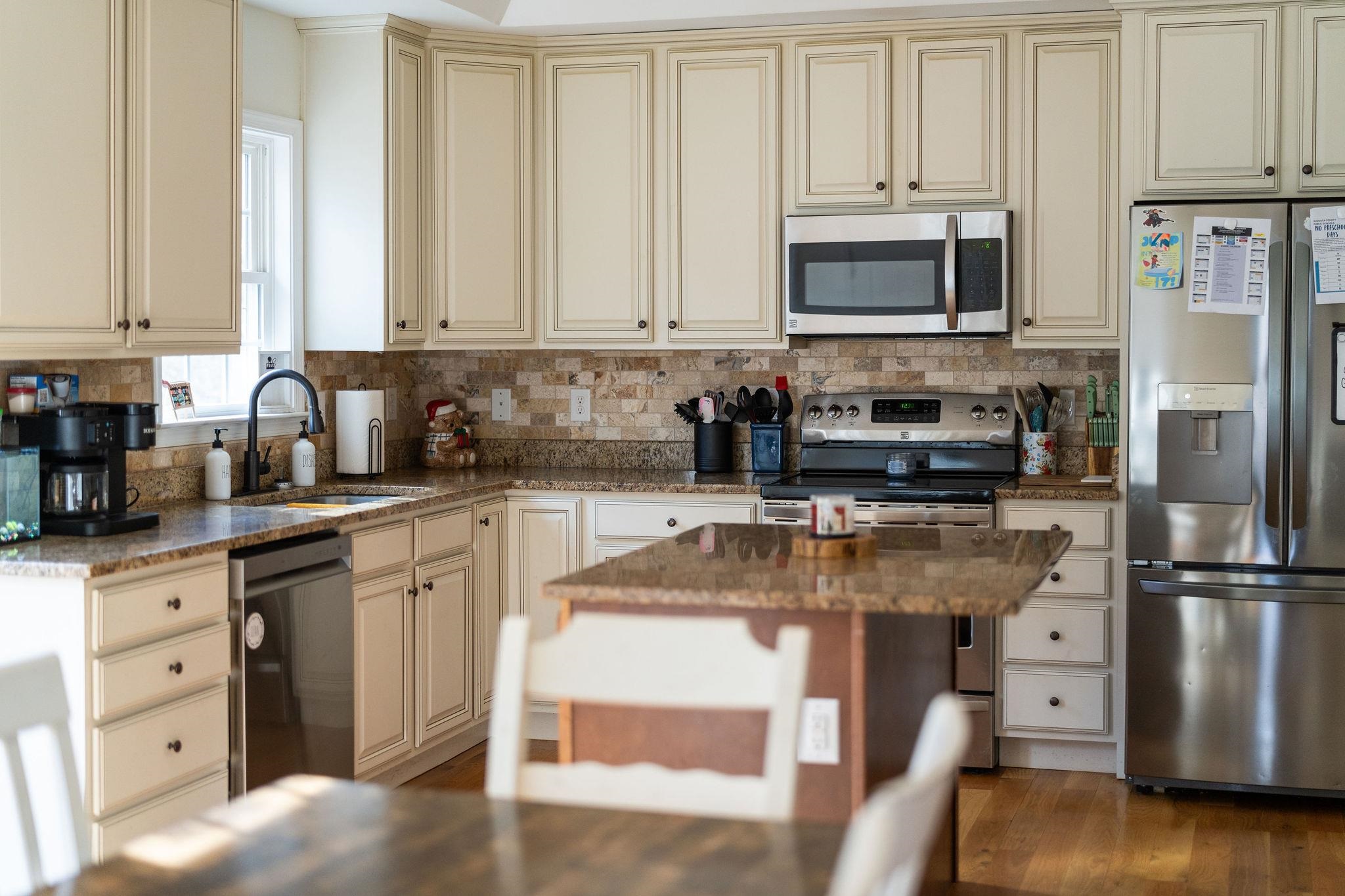 467 Reeds Gap Road Lyndhurst, VA 22952 - Photo 6 of 42 a kitchen with stainless steel appliances granite countertop a stove top oven a refrigerator a sink and dishwasher with wooden floor