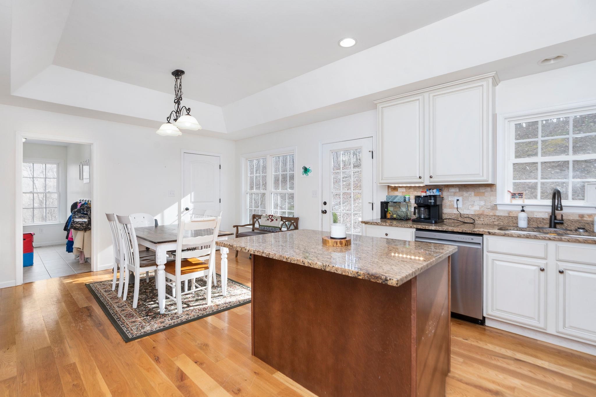 467 Reeds Gap Road Lyndhurst, VA 22952 - Photo 9 of 42 a kitchen with stainless steel appliances granite countertop a stove top oven a sink dishwasher and white cabinets with wooden floor