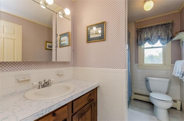 21 Schooner Ridge Marblehead, MA 01945 - Photo 21 of 30 a bathroom with a granite countertop sink a toilet and a mirror