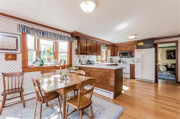 21 Schooner Ridge Marblehead, MA 01945 - Photo 9 of 30 a dining table with chairs and kitchen view