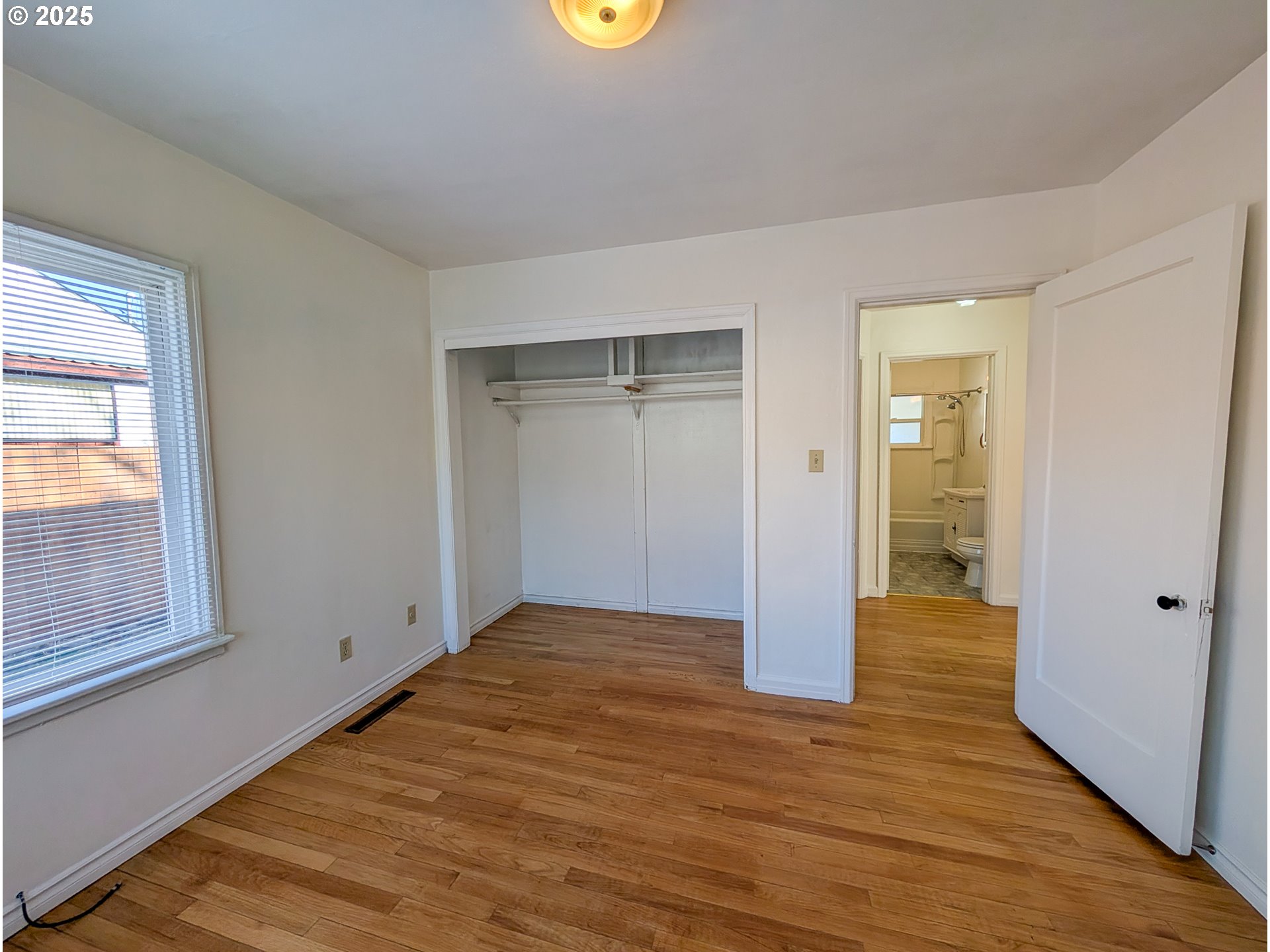 901 2nd Street La Grande, OR 97850 - Photo 11 of 19 a view of an empty room with wooden floor and a window