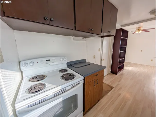 a kitchen with a stove and a refrigerator
