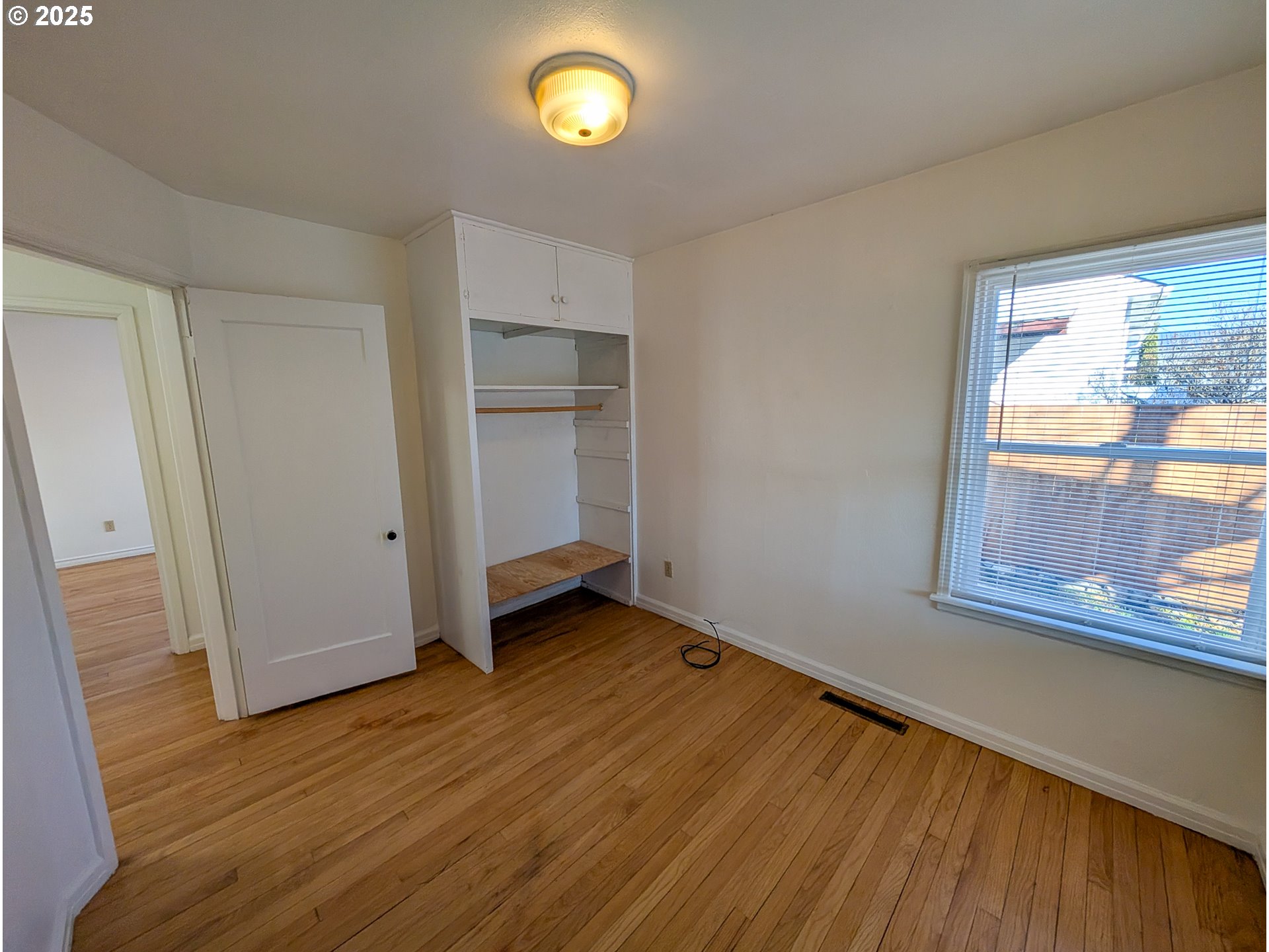 901 2nd Street La Grande, OR 97850 - Photo 9 of 19 an empty room with wooden floor and windows