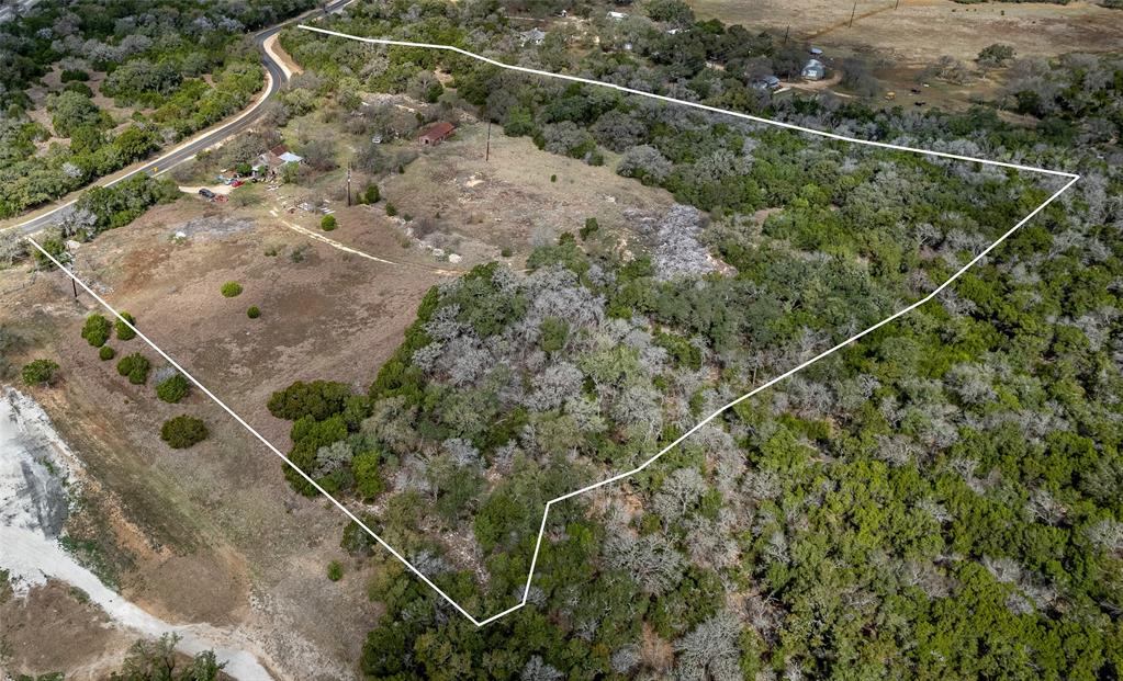 250 Mail Rte Road Fischer, TX 78623 - Photo 3 of 29 a view of a dry yard with wooden floor and fence