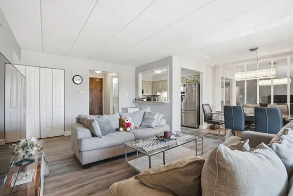 a living room with furniture and wooden floor