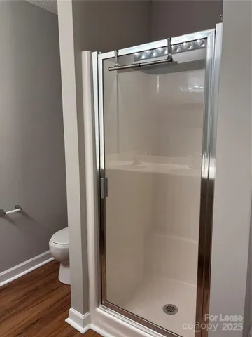 a bathroom with a glass shower door