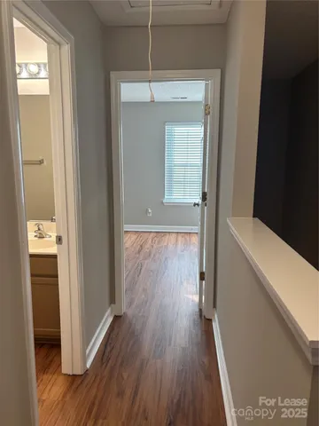 a view of hallway with wooden floor