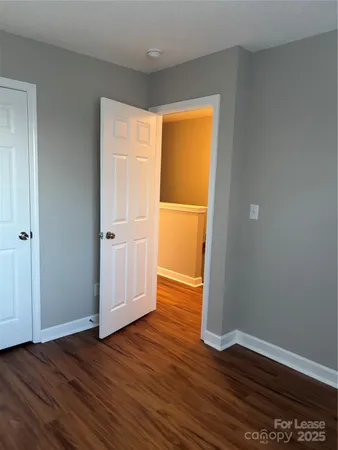 an empty room with wooden floor and doors